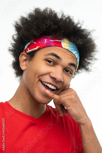 Young guy in red shirt looking contented and determined photo