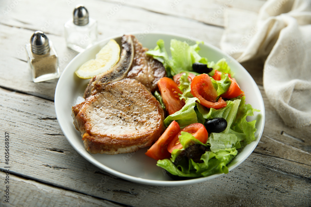 Baked pork chop with vegetable salad