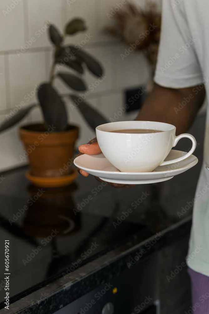 African american man hold cup in hand and offer tea African american man hold cup in hand and offer tea