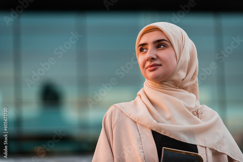 Photography Portrait of a Muslim business woman in hijab near the office building