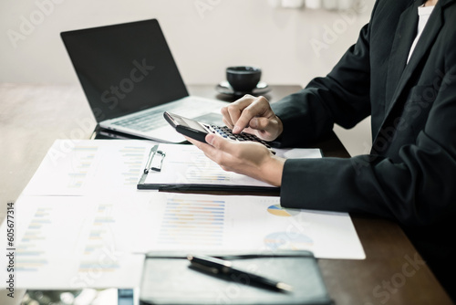 The businessman hand sits at their desks and calculates financial graphs showing the results of their investments planning the process of successful business growth