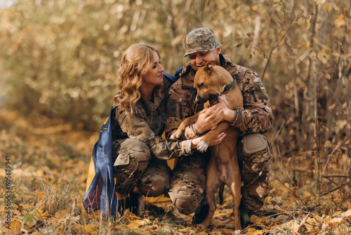A Ukrainian military couple meet their dog and play with him.