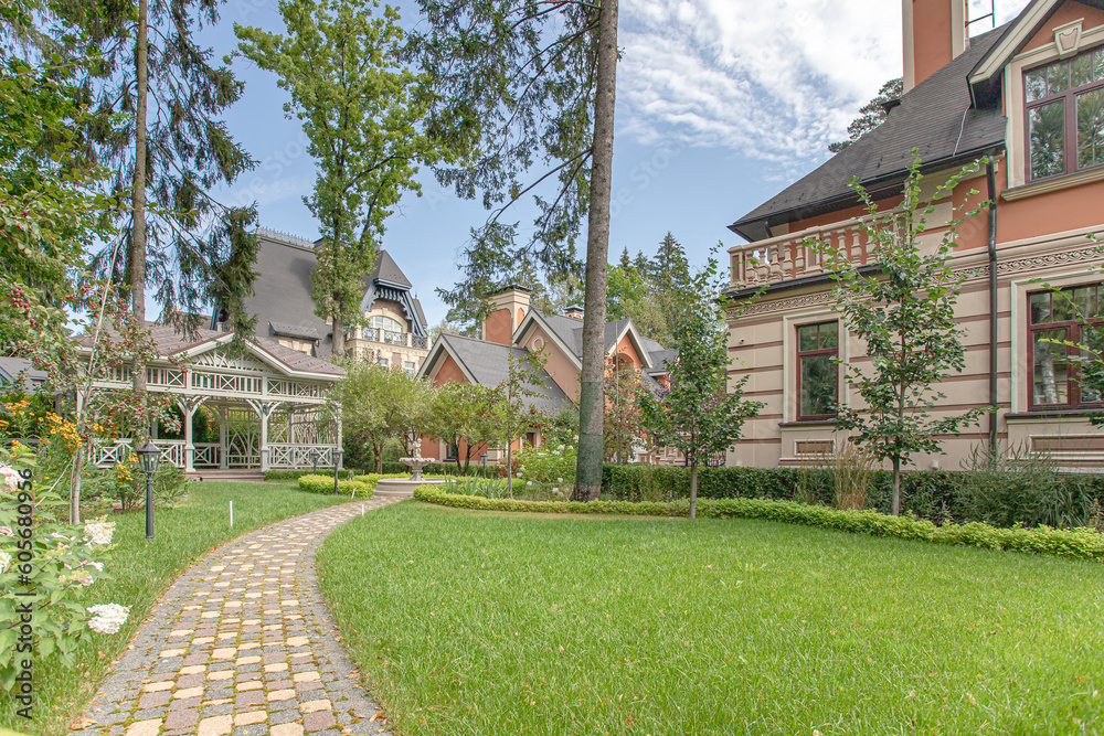 Fototapeta premium view of the sheared lawn with a path near the house