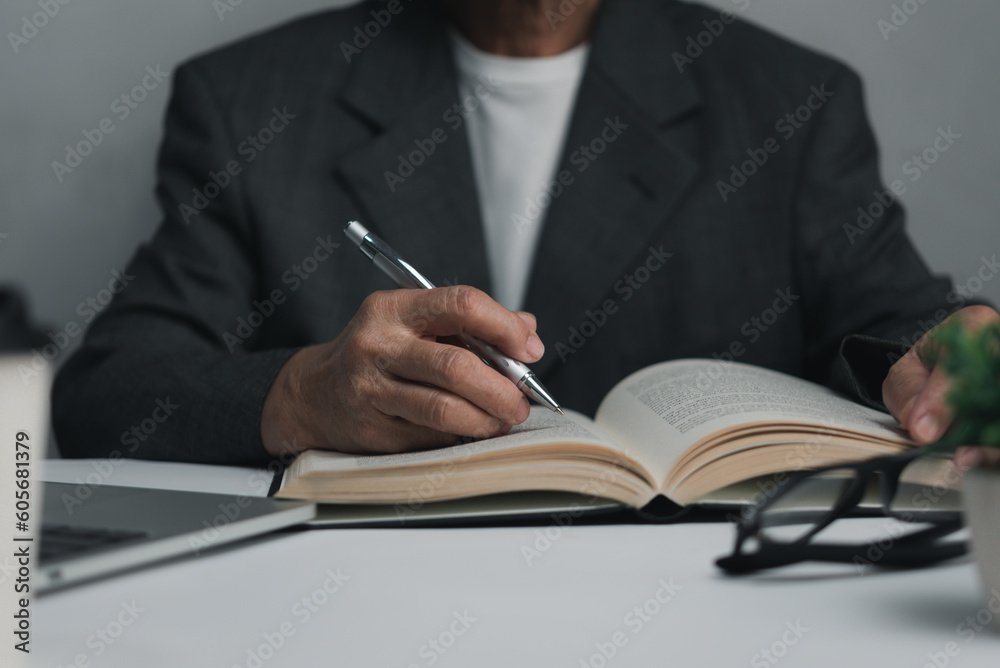Woman hands with pen writing on notebook in the office.learning, education and work.writes goals, plans, make to do and wish list on desk. Woman hands with pen writing on notebook in the office.learning, education and work.writes goals, plans, make to do and wish list on desk.