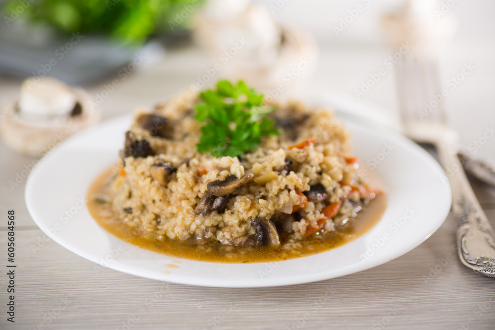 cooked bulgur with mushrooms, carrots and vegetables in a plate cooked bulgur with mushrooms, carrots and vegetables in a plate