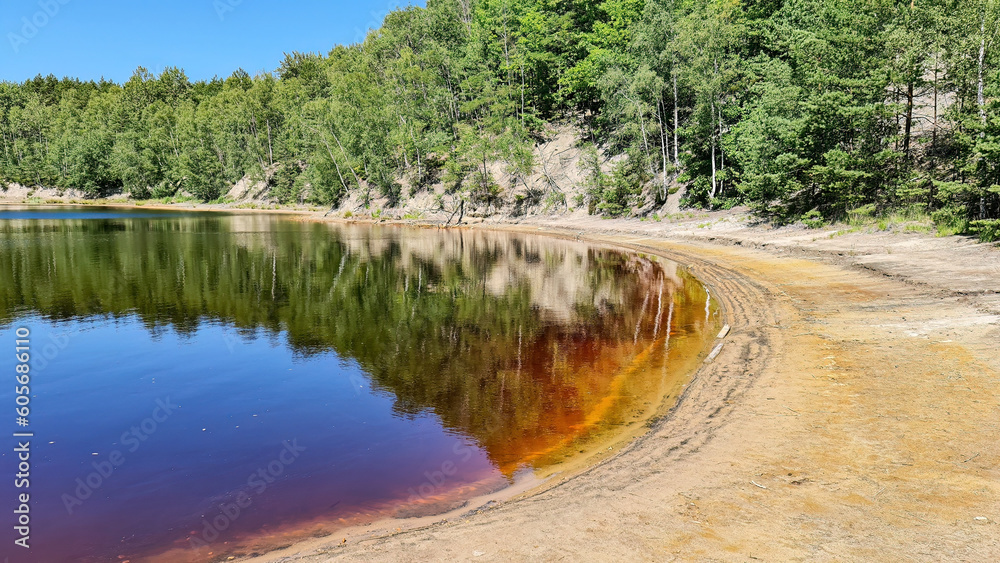 Red, yellow and blue, colorful waters of the Afryka lake in the Muskau Bend, the remins of the minining activity at the area. Red, yellow and blue, colorful waters of the Afryka lake in the Muskau Bend, the remins of the minining activity at the area.