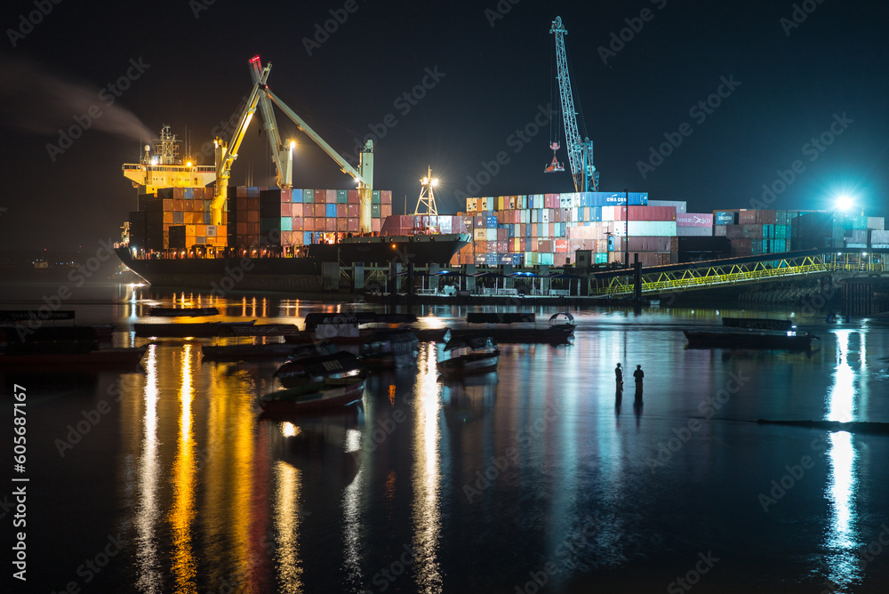 Night view / skyline of the Port of Zanzibar with container ships and a public fishing beach in the foreground _Tanzania, Africa