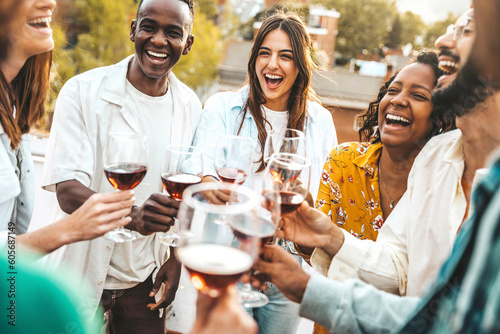 Fotobehang Multiracial friends celebrating rooftop party drinking red wine together - Cheer