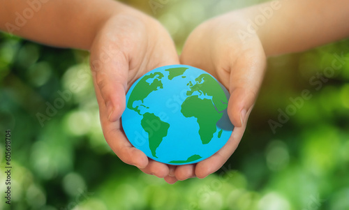 Hand holding paper cut saving clean energy earth globe world environment green eco friendly, save planet, csr social responsibility.campaign save the earth and earth Day 22 April