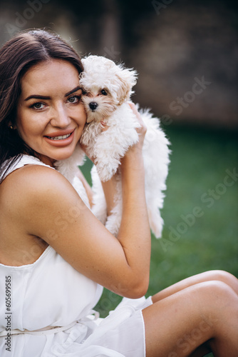 Beautiful woman holding her little maltipa dog