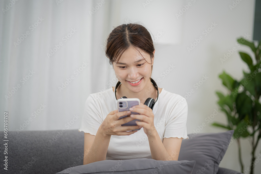 Relaxed young woman using smart phone spending time checking news social media Relaxed young woman using smart phone spending time checking news social media