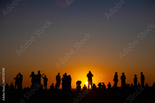 Silhouette of people at sunset © scottimage