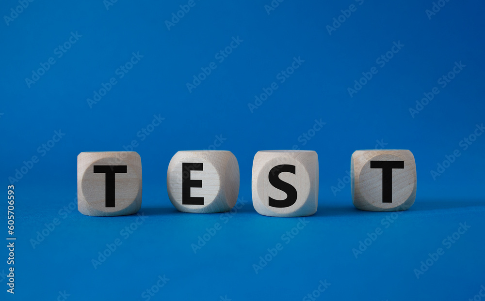 Test symbol. Concept word Test on wooden cubes. Beautiful blue background. Business and Test concept. Copy space. Test symbol. Concept word Test on wooden cubes. Beautiful blue background. Business and Test concept. Copy space.