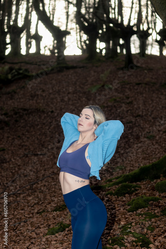 Nature's Gym: Witness the Dedication and Poise of a Blonde Woman Exercising in the Forest