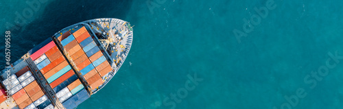 Fotografie, Obraz Top-down aerial view of a large container cargo ship moving over the open ocean with copy space