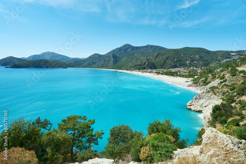 Fototapeta Naklejka Na Ścianę i Meble -  Scenic coastal landscape featuring crystal clear azure blue water and a captivating view of Oludeniz Blue Lagoon, Southern Coas of Turkey