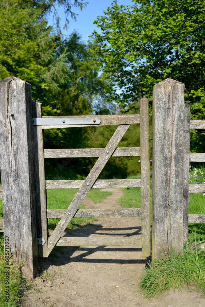 A wooden gate standing across a public footpath in the British countryside. A wooden gate standing across a public footpath in the British countryside.