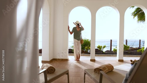 Mediterranean stylish Caucasian female arriving at luxury hotel 