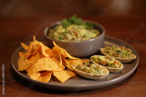 Guacamole, traditional mexican food with avocado and tortillas.
