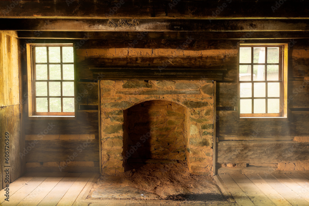Rustic log cabin interior with light rays throughout the windows and wood floors Rustic log cabin interior with light rays throughout the windows and wood floors