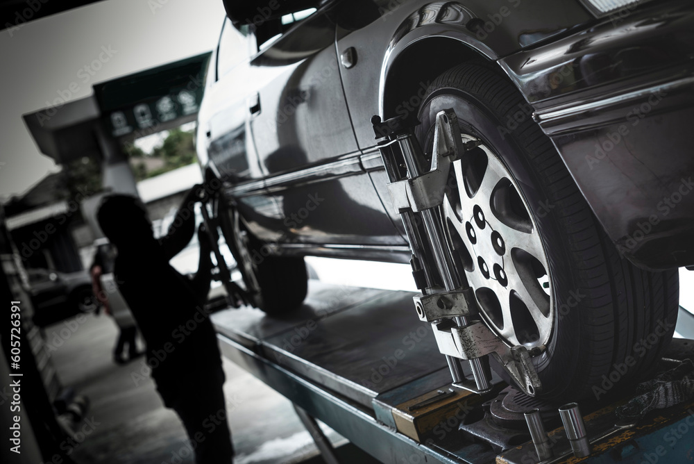 Fototapeta premium Car wheel alignment services in garage service shop. 
