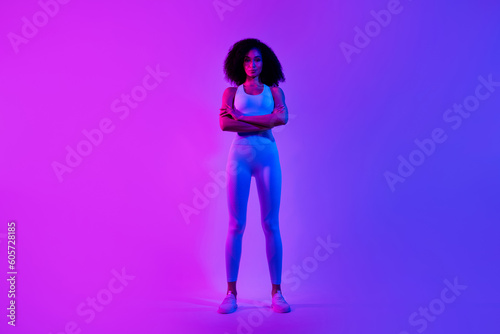 Full length photo of slim great shape self improvement coach folded arms posing isolated on blue pink color neon background