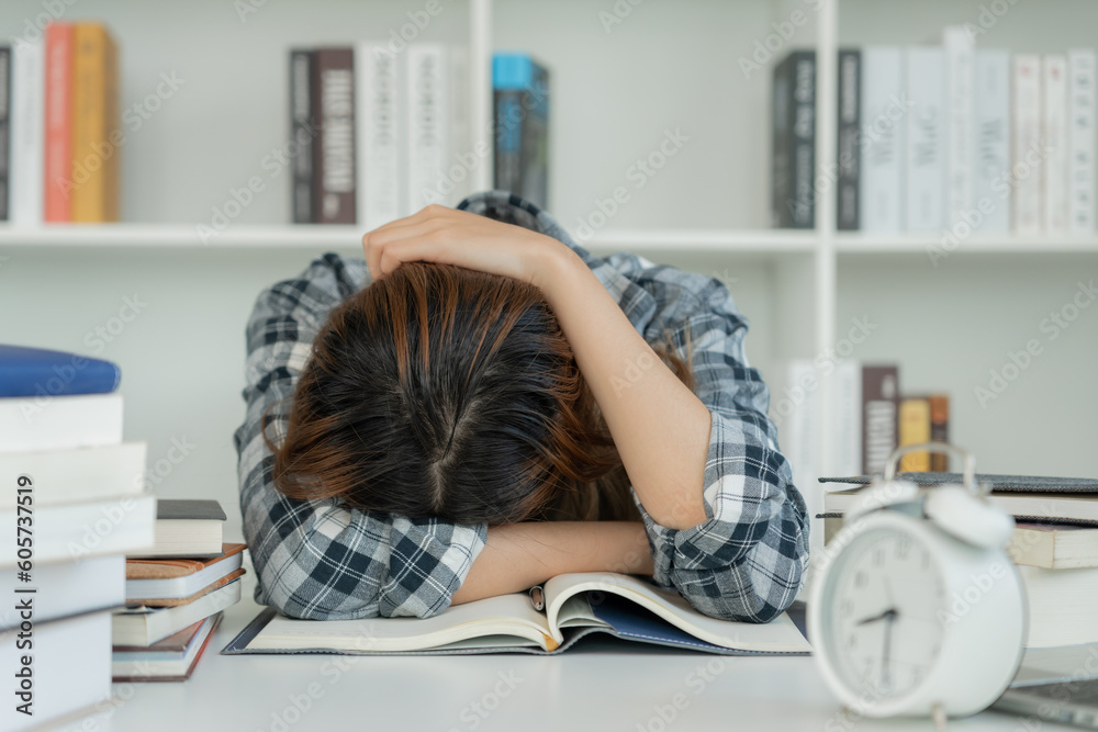 Asian student woman have anxiety because of exams, female prepare for test and learning lessons in the library. stress, despair, haste, misunderstanding reading, discouraged, expectation, knowledge Asian student woman have anxiety because of exams, female prepare for test and learning lessons in the library. stress, despair, haste, misunderstanding reading, discouraged, expectation, knowledge