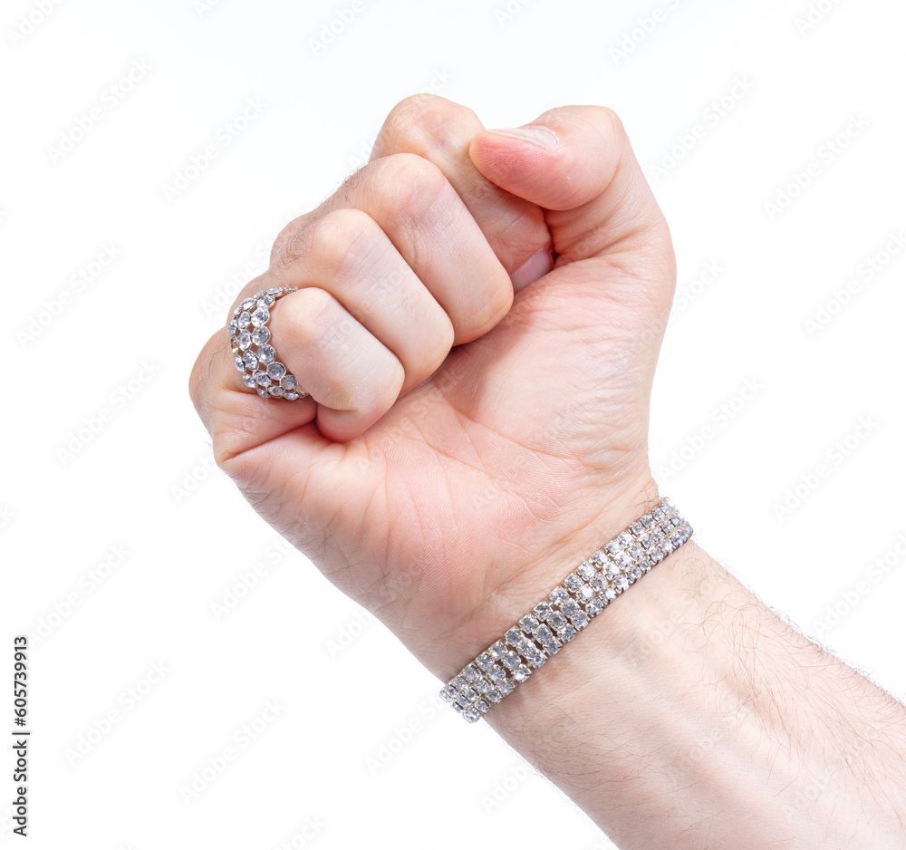 Large diamond ring and bracelet on the hand on a male adult