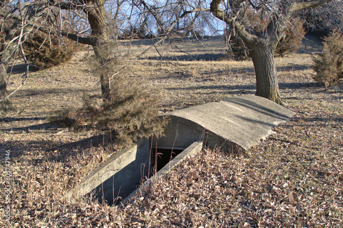 Rural farm Tornado underground shelter made from concrete with fall colors surrounding the bunker.