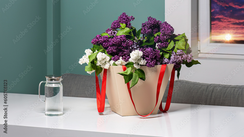 Package mockup for flowers in hands with a bouquet of lilacs without a logo