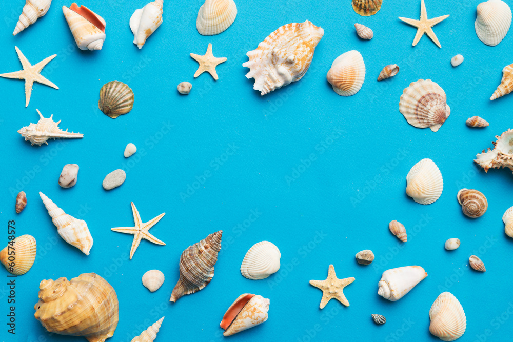 Summer time concept Flat lay composition with beautiful starfish and sea shells on colored table, top view Summer time concept Flat lay composition with beautiful starfish and sea shells on colored table, top view