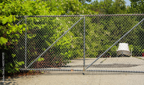 Chain link fence with barbed wire: a symbol of confinement, security, restriction, and the divide between safety and danger © Your Hand Please