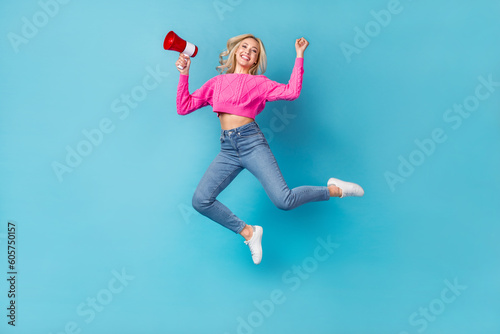 Full length size photo of energetic happiness woman wear pink sweater fist up hold megaphone hooray shopping isolated blue color background