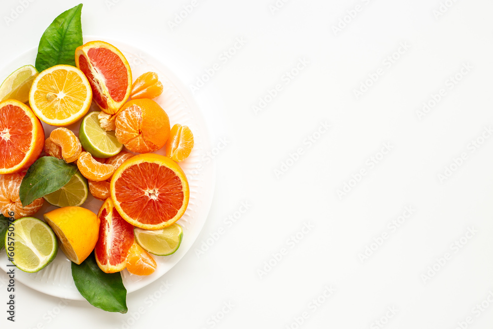 Layout of citrus fruits on white plate top view Layout of citrus fruits on white plate top view