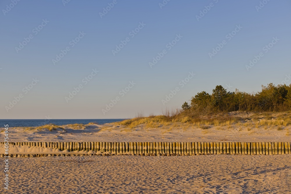 An empty beach during the golden hour in Łazy and Unieście in the West Pomeranian Voivodeship in Poland.