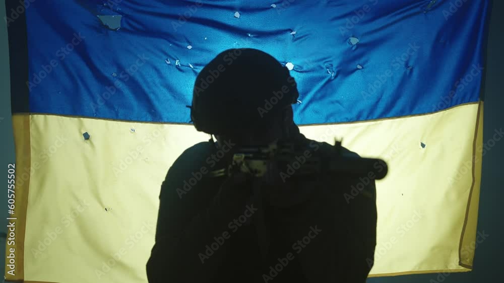 Close up of the silhouette of a Ukrainian soldier with a rifle in his ...