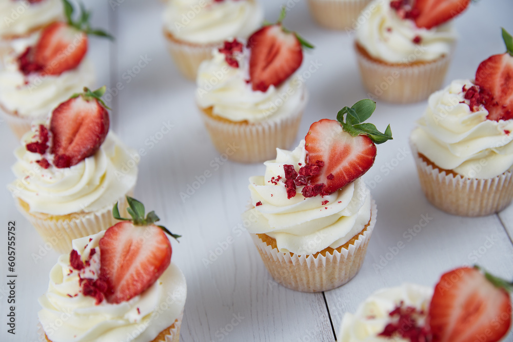 Strawberry cupcakes on white wooden planks