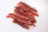 Dried pork isolated on white background. Pieces of dry meat. Beer snack.
