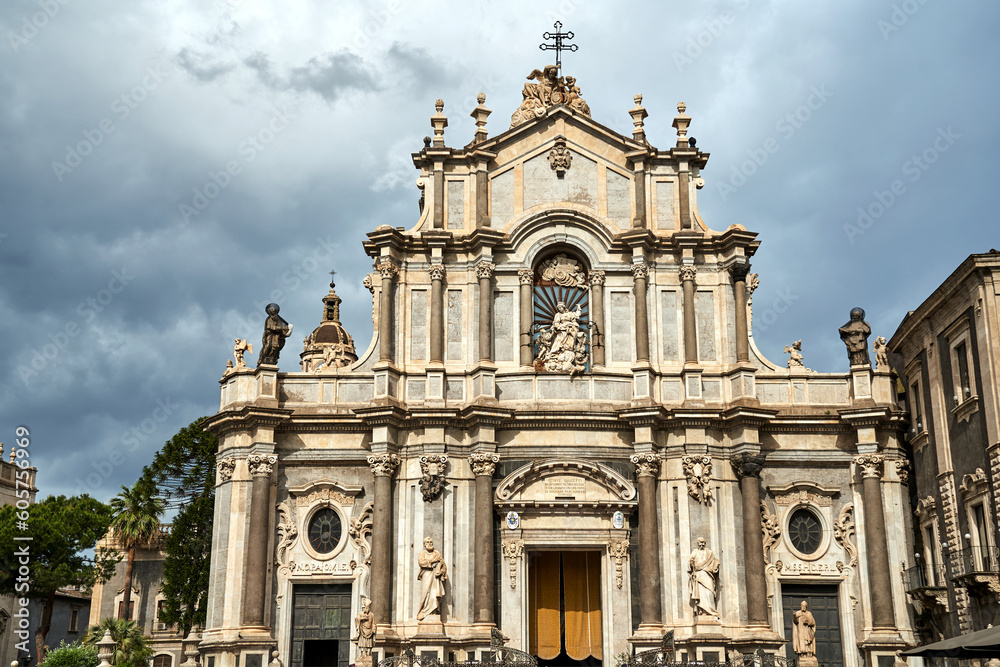 Columns and statues of the Baroque facade of the Cathedral Basilica of St. Agates in the city of Catania
