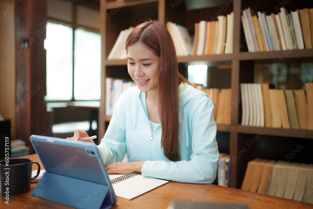 University of College students discussing with assignment in library, Education concept. University of College students discussing with assignment in library, Education concept.