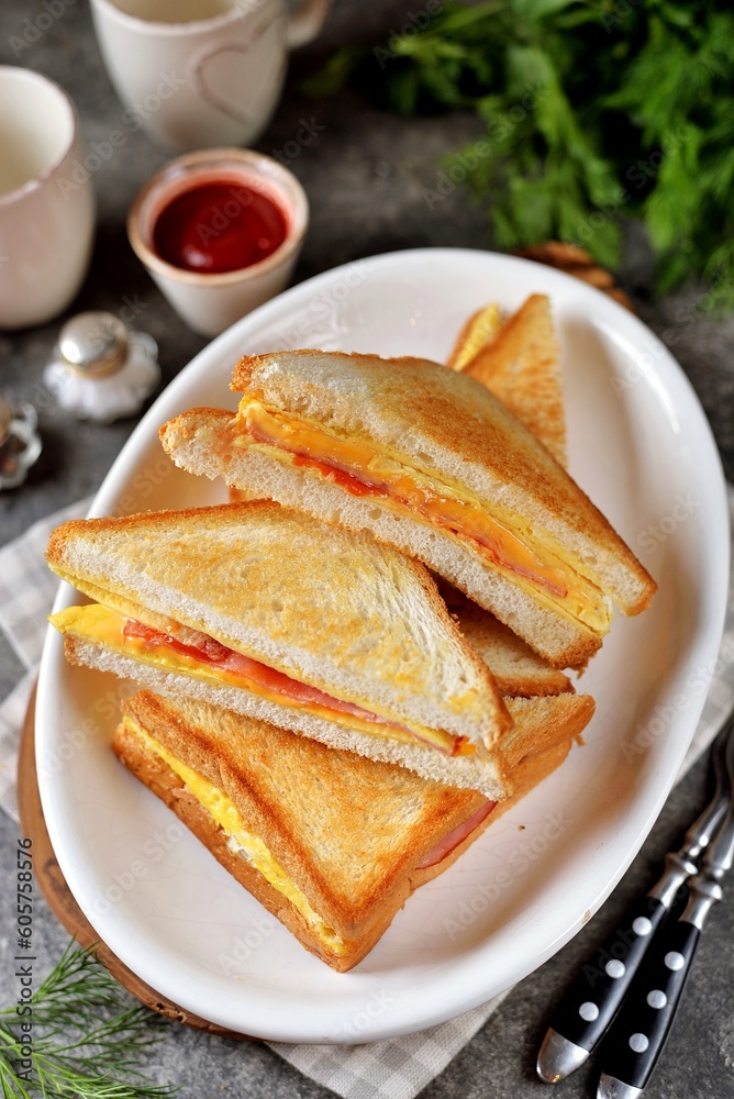 Sandwiches with egg, ham and toast cheese fried in a pan Sandwiches with egg, ham and toast cheese fried in a pan