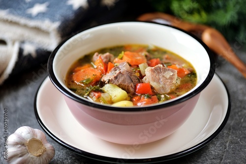 Thick soup with beef, potatoes, tomatoes and bell peppers.