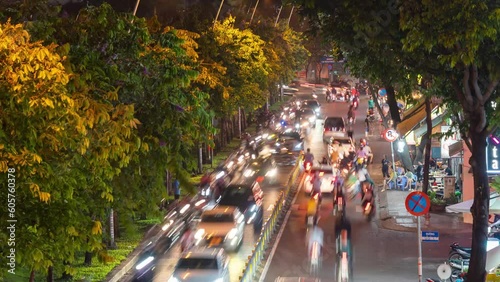Hyperlapse view of busy traffic during sunset and night, colorful perspective of Ho Chi Minh city with numerous coffee shops, crowded with people, motorbikes