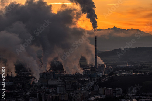 Colorful sunset over industrial city. with smoke and steam from chimney.
