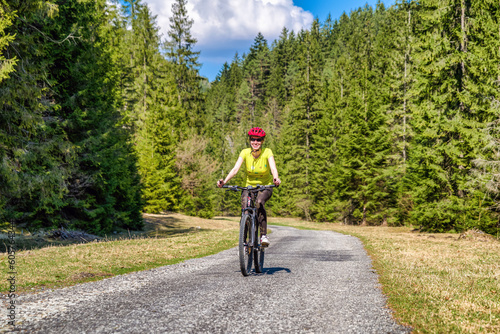 Woman on bike in forest. Healthy lifestyle. Outdoor activity