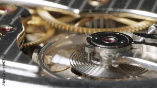 Slow motion mechanical pocket watch escapement with gears in background - 4K