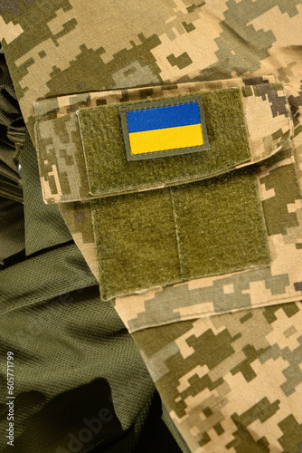 Elements and symbols of the military on the background of the Ukrainian flag, with chevrons and shoulder straps.