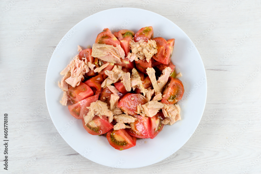 Tomato from the garden with tuna on a white plate Tomato from the garden with tuna on a white plate