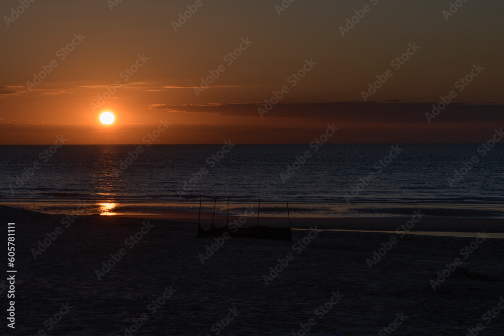 Landscape Sunset on the sea. Almost dark Deserted sandy beach. Place for text