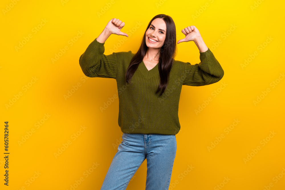 Photo of shiny adorable woman dressed khaki sweater pointing thumbs herself isolated yellow color background Photo of shiny adorable woman dressed khaki sweater pointing thumbs herself isolated yellow color background